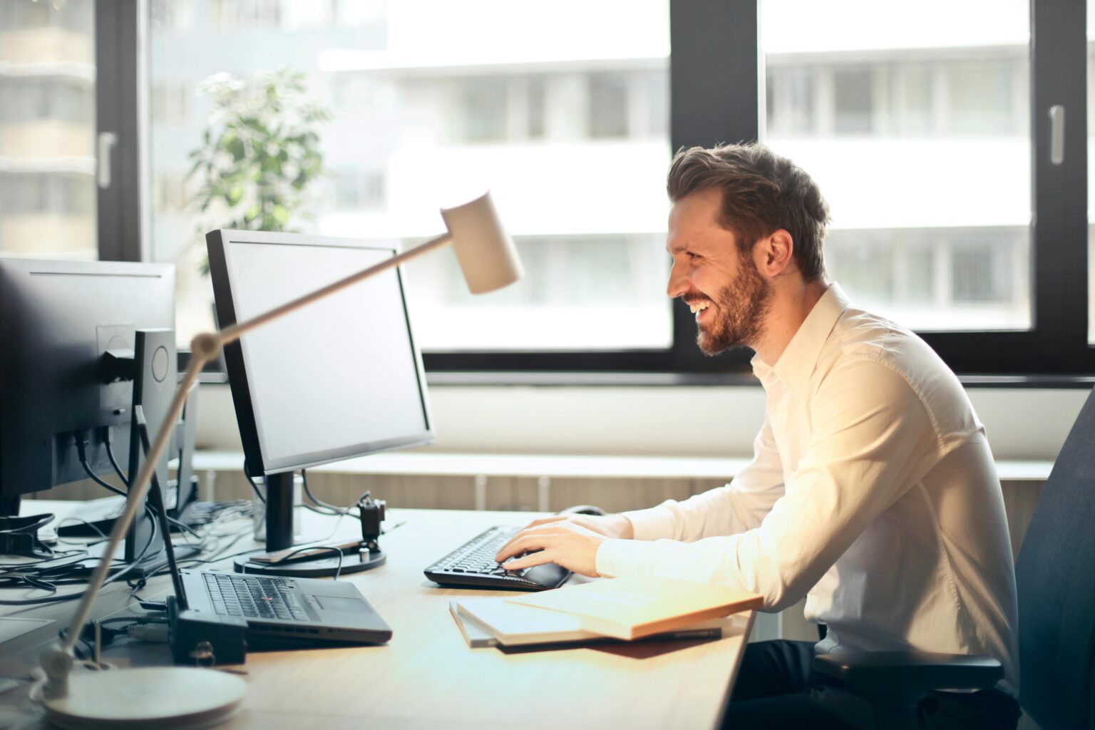 a man at a desk using a computer